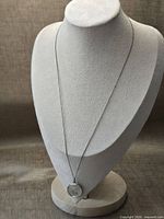 Full view of necklace on display bust showing chain length and pendant placement
