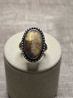 Top view showing oval cabochon and dotted bezel