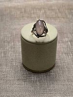 Front view of sterling silver ring on display stand showing stone and setting