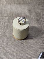 Front angled view of sterling silver ring on display stand