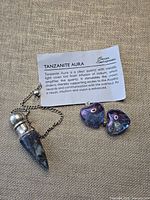 Full set showing pendulum, two heart pendants, information card