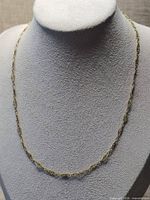 Full view of necklace draped on bust form