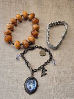 All three bracelets arranged on fabric background