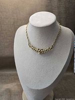 Full view of necklace on bust showing overall shape and chain length