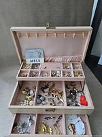 Open Mele box showing compartments filled with assorted jewelry