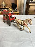 Side view showing red Overland Circus wagon, horse, driver, wheels