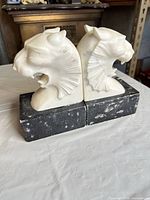 Front angled view showing both marble lion head bookends and bases