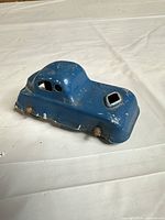 Top and side view of blue pressed metal toy car