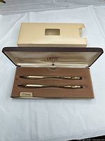 Open Cross case displaying gold-filled pen and pencil labeled 0.5 mm