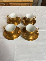 Top view showing four cups on saucers