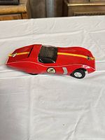 Side view of red toy race car showing stripe and #5 decal