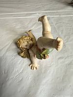 Full view of cherub figurine front in upside-down pose