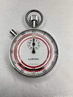 Front view showing Lustro dial, timing scales, crown and pusher
