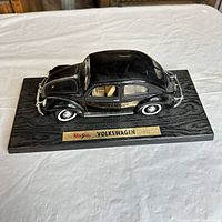 Side view of black 1951 VW Beetle on display base
