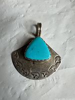 Front view of sterling silver pendant with turquoise stone