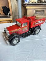 Front three-quarter view of red Nylint Coal & Gravel metal dump truck