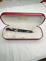 Pen in red presentation case, plastic wrap intact