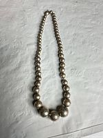 Entire necklace laid flat showing full length and bead sizes