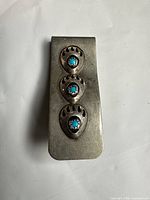 Front view showing three bear-paw turquoise motifs