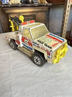 Front left side view showing decals, push bar, wheels