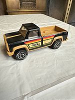 Left side view of Tonka truck showing graphics and wheel design