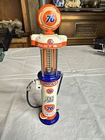 front view of Union 76 visible gas pump model showing globe, cylinder, base, nozzle and hose