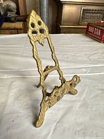 Full side view of brass ornate tabletop easel stand