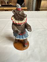Front view of cast iron bear in costume