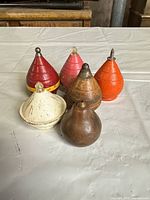 Six wooden spinning tops grouped together