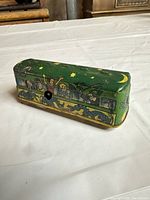 Side view showing green lithographed body, window passenger graphics, wind-up aperture