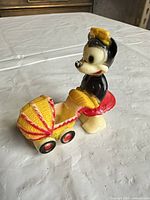 Left front perspective of Minnie Mouse vinyl figurine and stroller