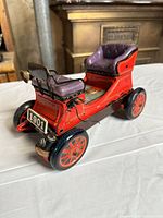 Left side view showing overall car, seat, wheels, headlamp