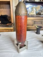 front view showing wood body, metal nose, stand