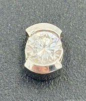 Front view showing round diamond in 14k white gold half-bezel setting