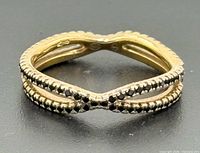 Top view of bypass ring showing gold gilt finish and marcasite rows