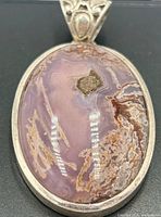 Front view of pendant showing agate cabochon and bezel