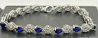 Full view of bracelet showing alternating sapphire and clear stone links