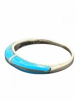 Angled view of sterling silver ring highlighting blue inlay