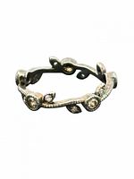 Front view of sterling silver vine motif ring showing leaf shapes and stones