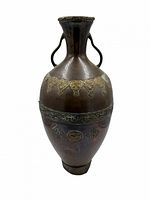 Full view front of bronze jug showing overall shape and decoration
