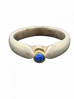 Front view showing silver band and bezel-set blue opal