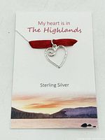 Front view of sterling silver heart pendant on presentation card