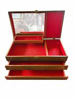 Box open showing red felt interior, removable tray, ring slots, drawers