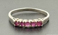 Top view showing five red rubies in row on sterling band