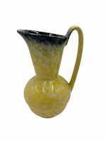 Full side view of yellow mottled ceramic ewer vase