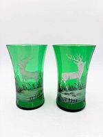 Front view of both green glass tumblers showing deer design