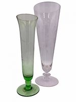 Both pilsner glasses side by side showing colors and etched design