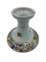 Full view of porcelain candlestick showing floral pattern and gold trim