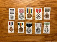 Front view of ten cigarette cards showing medal illustrations