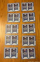 Fifteen sealed Marvel trading card packs laid out on a wooden surface showing backs with Marvel Mission branding
